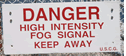 Danger High Intensity Fog Signal Keep Away warning sign posted by Coast Guard