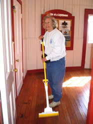 Volunteer mops the floor.