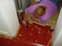 Trez works inside removing carpeting.