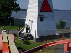 Ranger Barbara unlocks the lighthouse under the watchful eye of the National Guard.